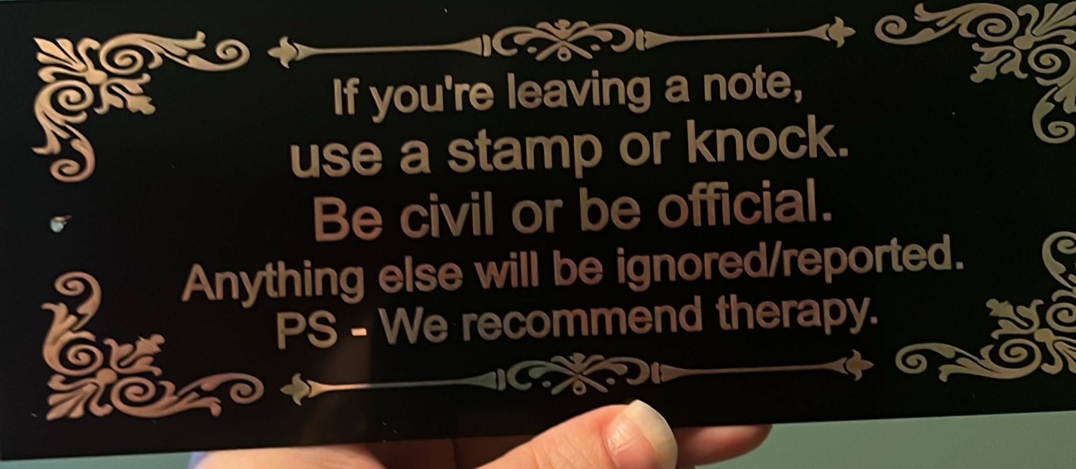 Door sign that reads "If you're leaving a note, use a stamp or knock. Be civil or be official. Anything else will be ignored/reported. PS - We recommend therapy.