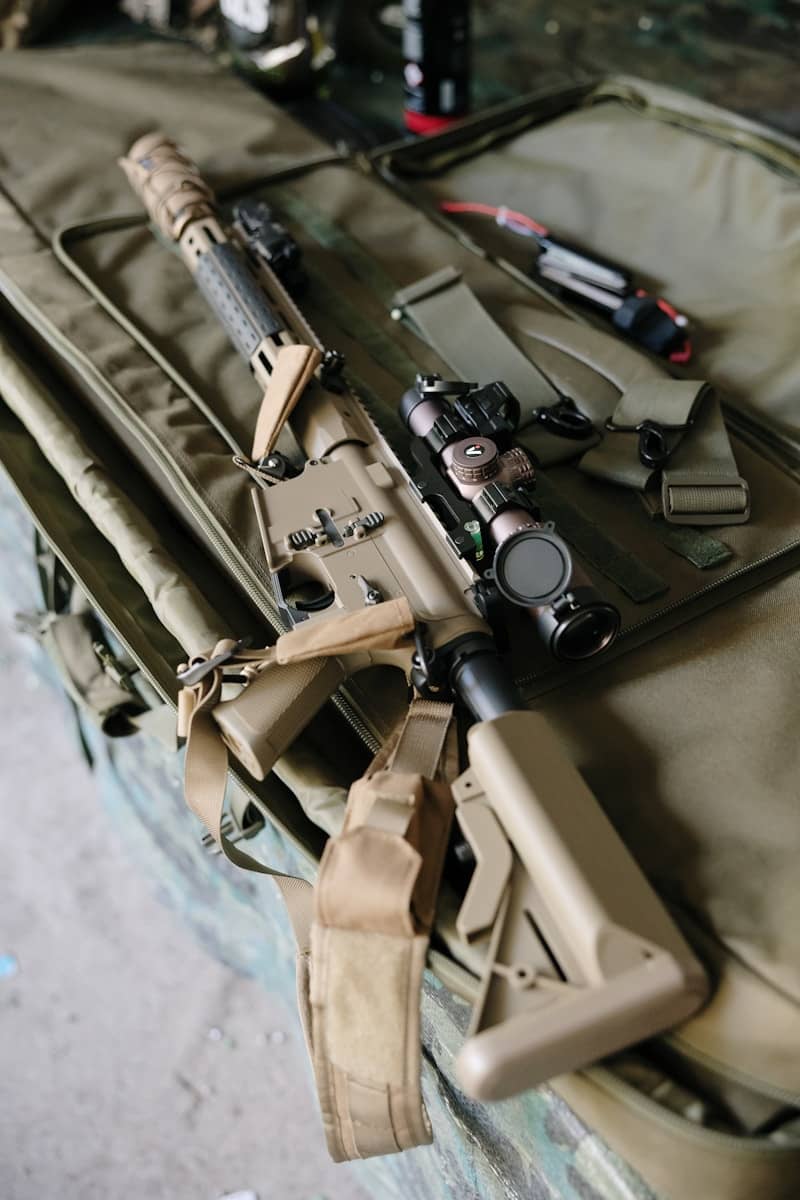 Tan assault rifle with scope in case