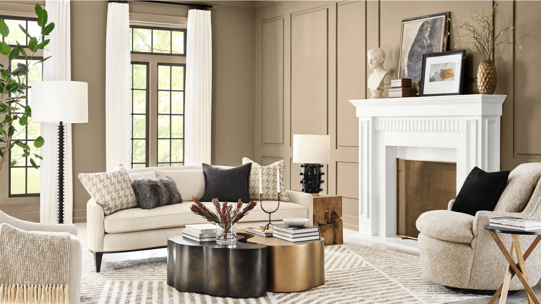 a modern living room with a white sofa and throw pillows. The walls are painted Sherwin Williams 2026 color of the year Universal Khaki 