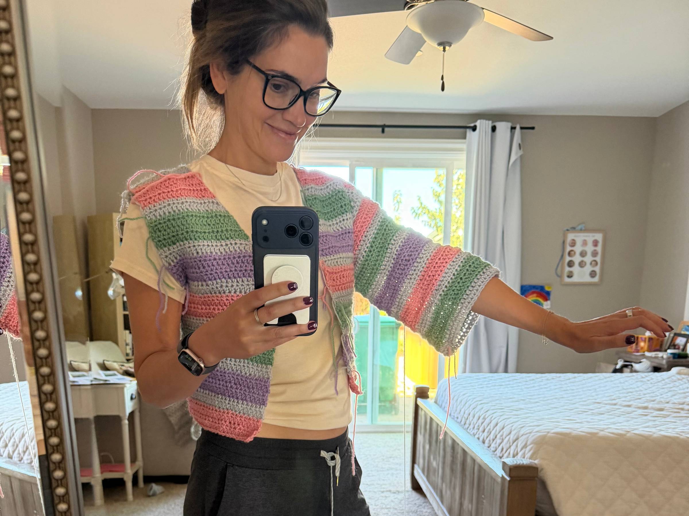 Ashleigh trying on the striped cardigan mid-make to check the fit