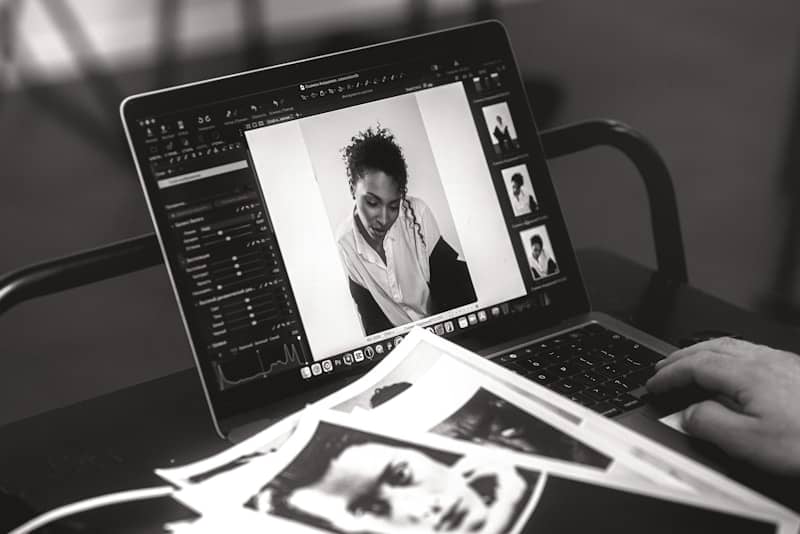 Someone edits a photo on a laptop.