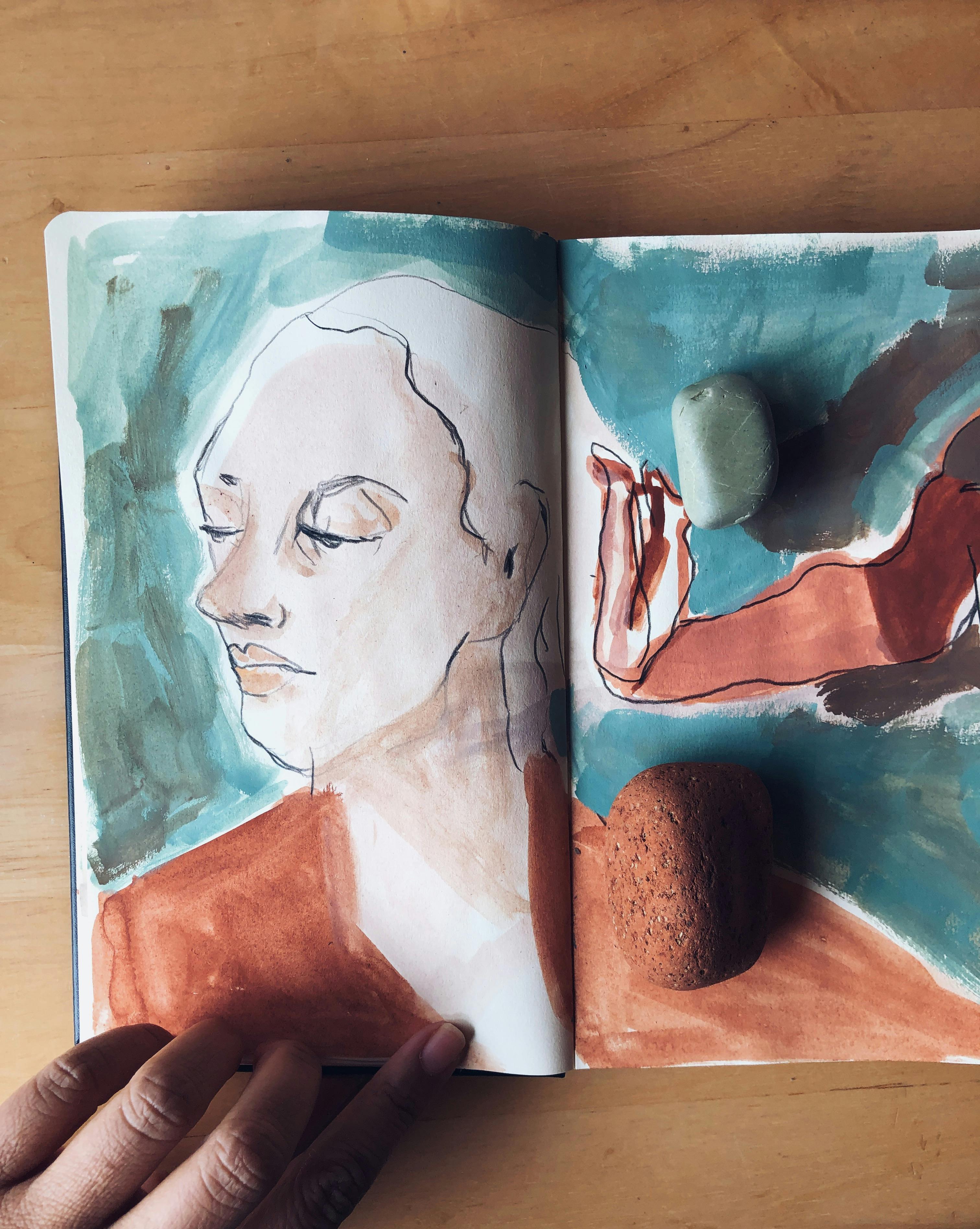 A sketchbook with a portrait of a woman