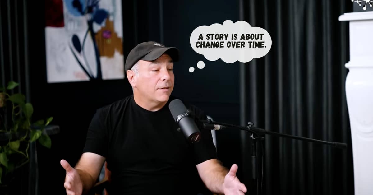 Matthew Dicks is wearing a black baseball cap and black t-shirt, sitting in a cozy studio talking into a mic.