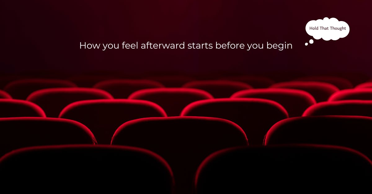 Red velvet chairs in a dark auditorium. Quote reads, “How you feel afterward starts before you begin”.