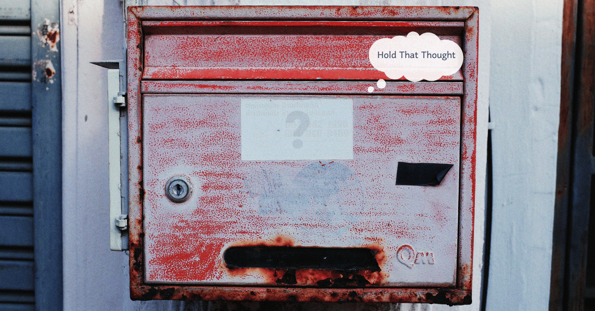 A worn post box resembling a haggard face. A question mark sits in the center.