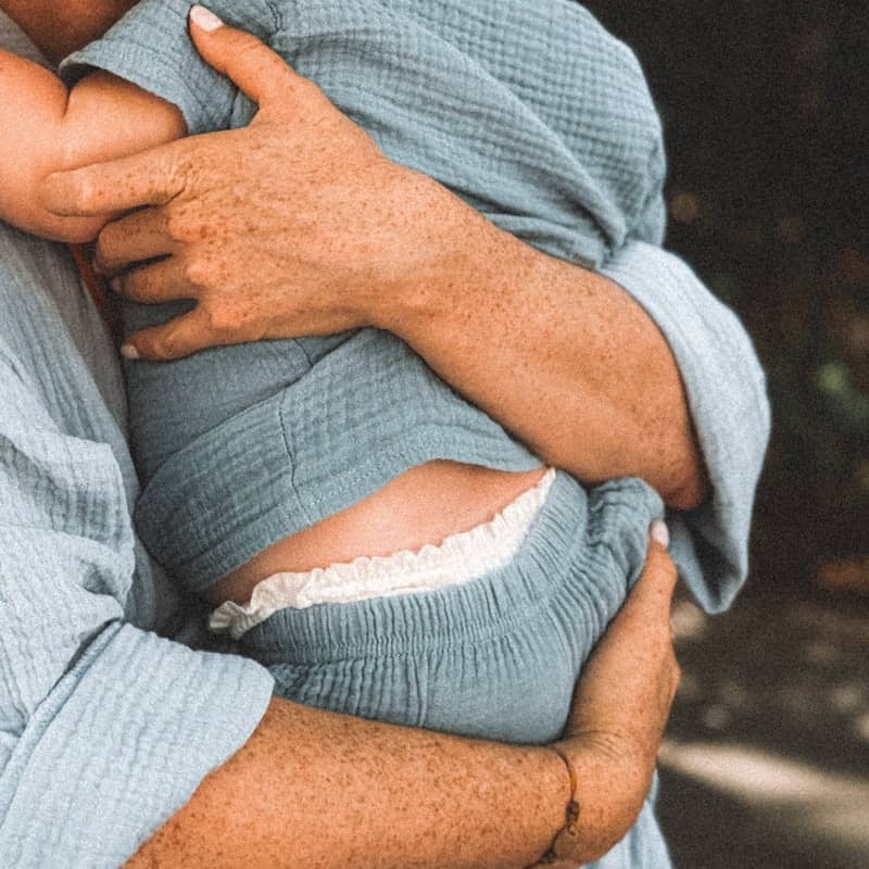 a man holding a baby in his arms