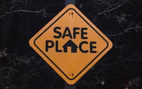 A yellow sign that says safe place on it