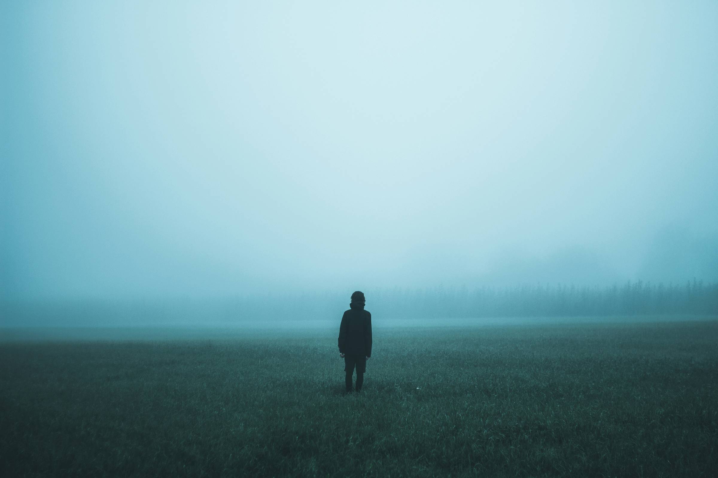 A person standing in front of dense fog