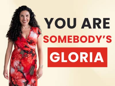 Woman in red dress next to text: 'You Are Somebody's Gloria.