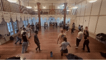 a circle of people dancing salsa, constantly rotating partners