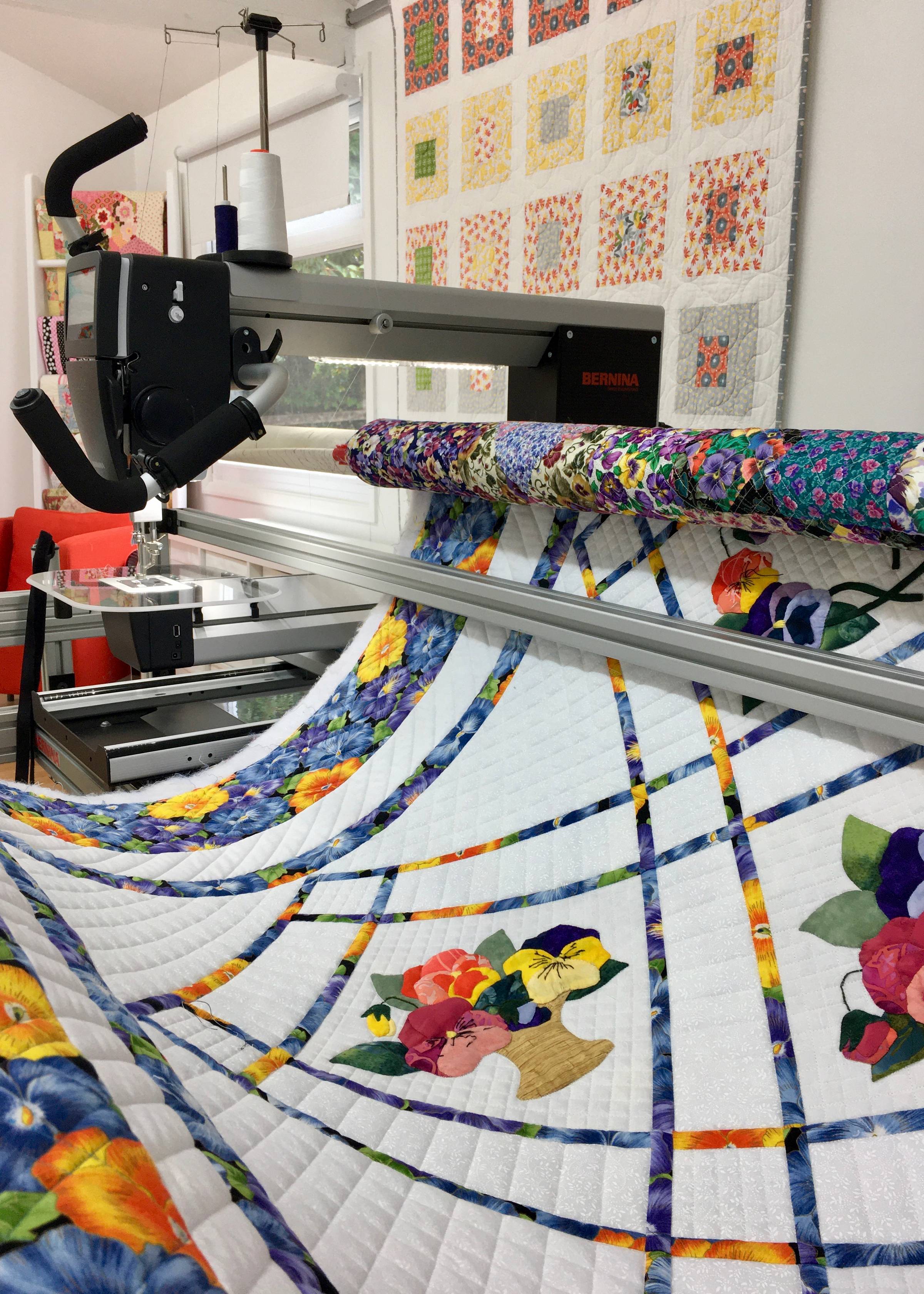 A longarm with a quilt on the frame
