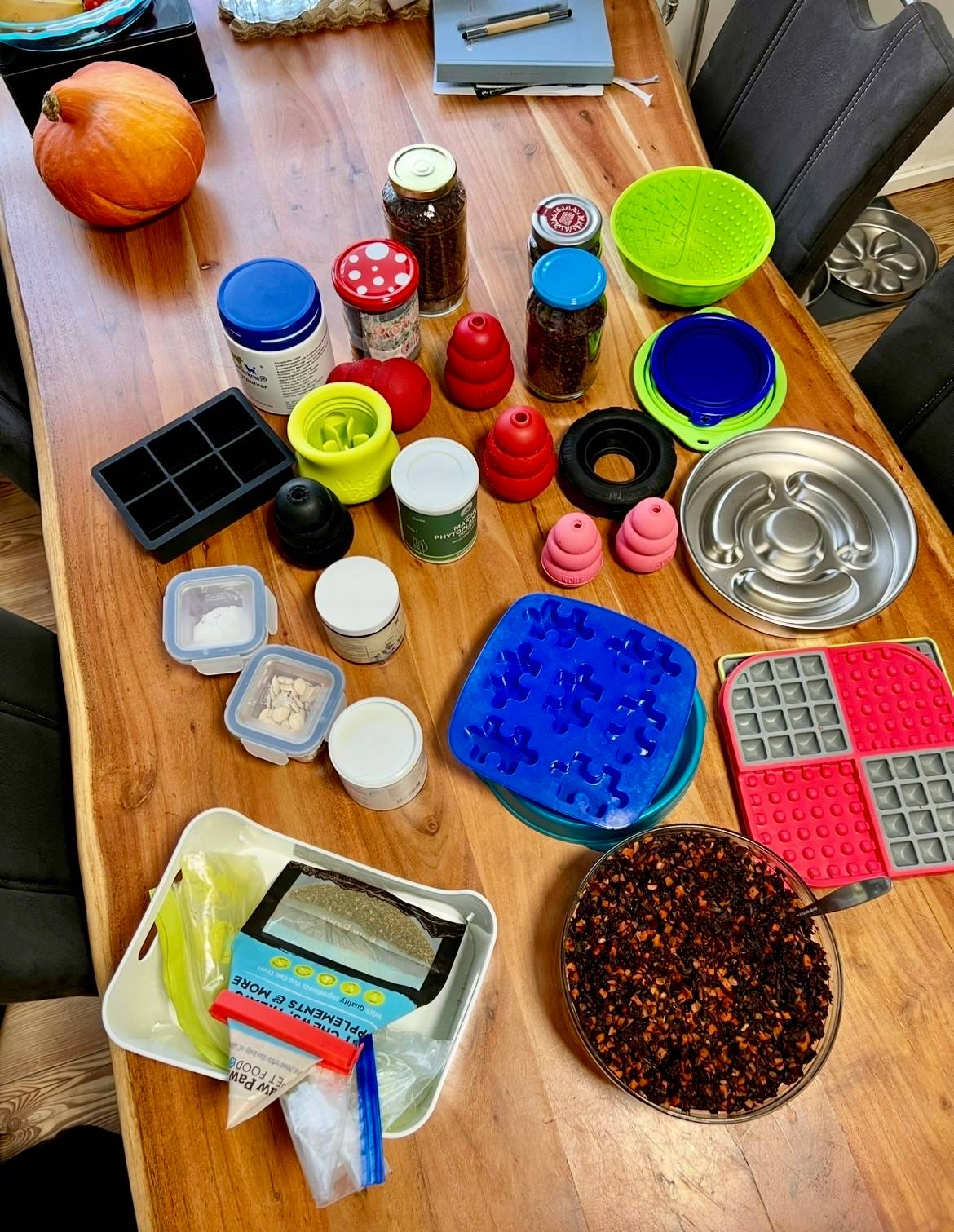 Miscellaneous items from a dog kitchen cabinet on a wooden table