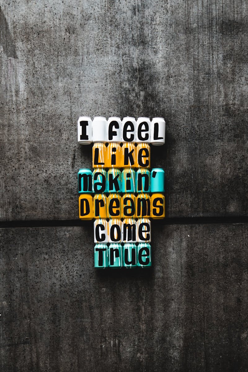 photo of multicolored can wall decor with motivational quote