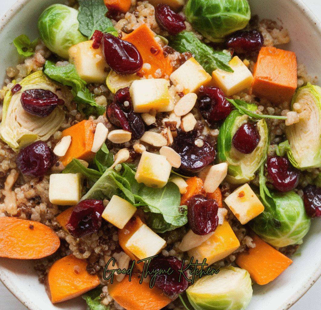 A colorful quinoa salad with roasted Brussels sprouts, sweet potatoes, almonds, cherries, cheese, and a sweet maple balsamic dressing.