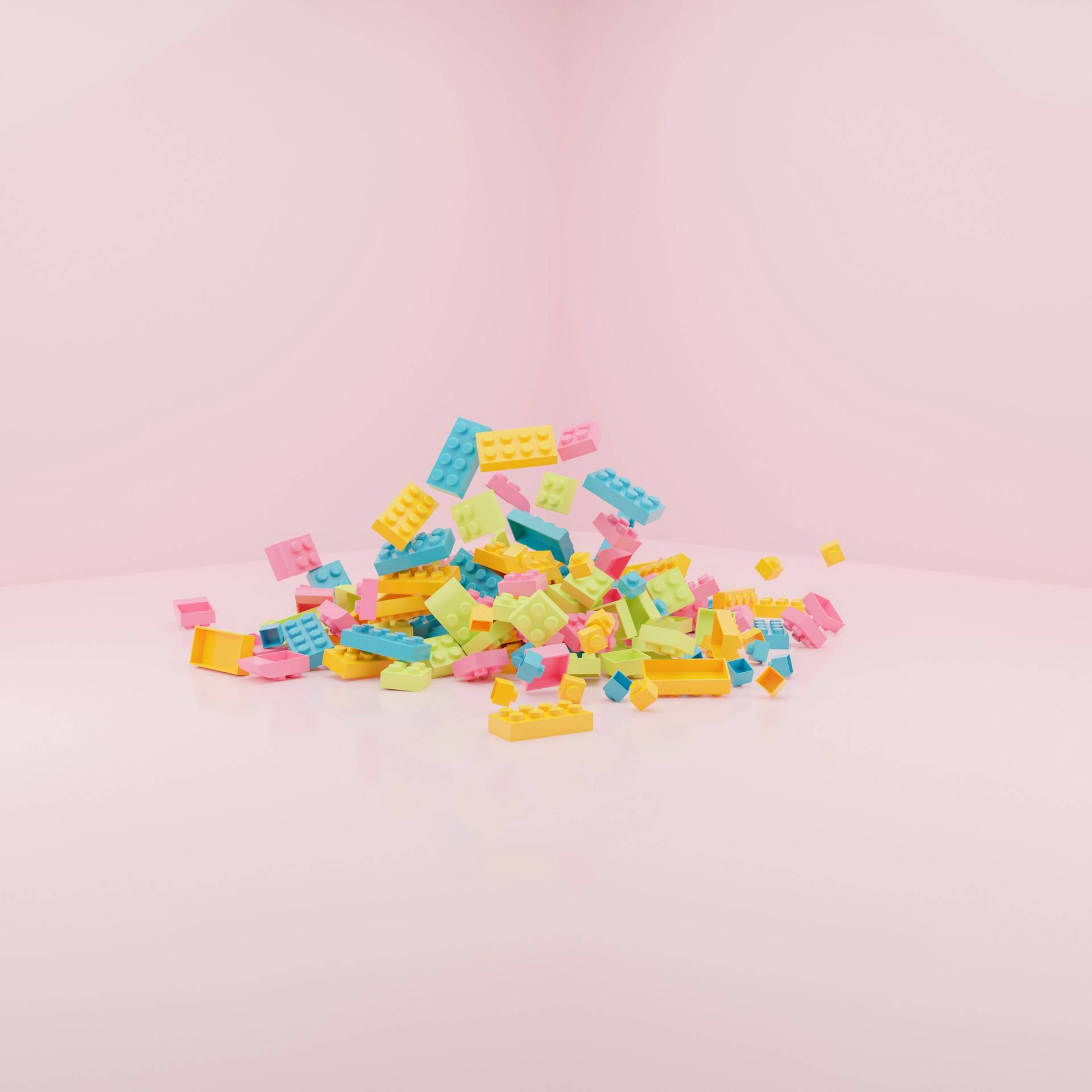 Pastel Lego bricks tumbling onto pink background, evoking childhood play and creative joy.