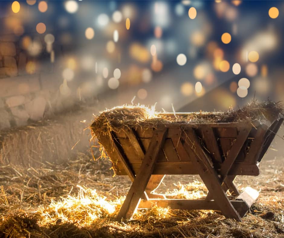 A rustic manger bathed in golden light, symbolizing the promise of Advent