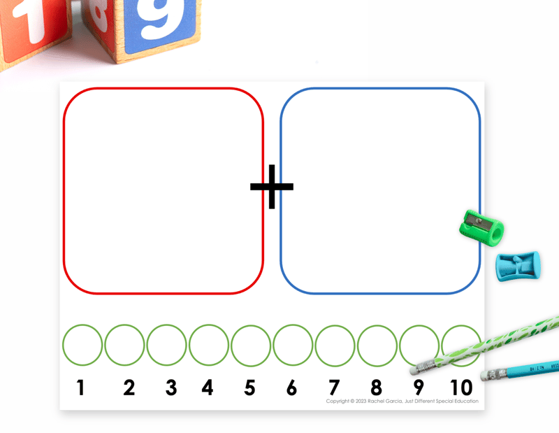 paper addition mat on white background with blocks, pencils and sharpeners scattered around