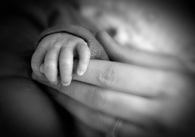 a close up of a person holding a baby