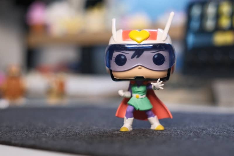 Funko pop superhero figure with helmet and cape.