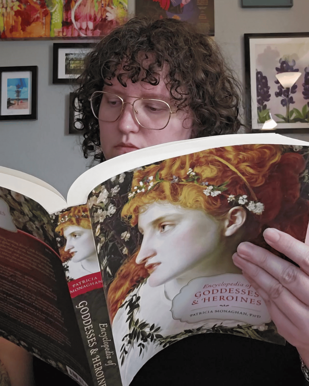 A picture of Megan Winkler reading a book, Goddesses and Heroines