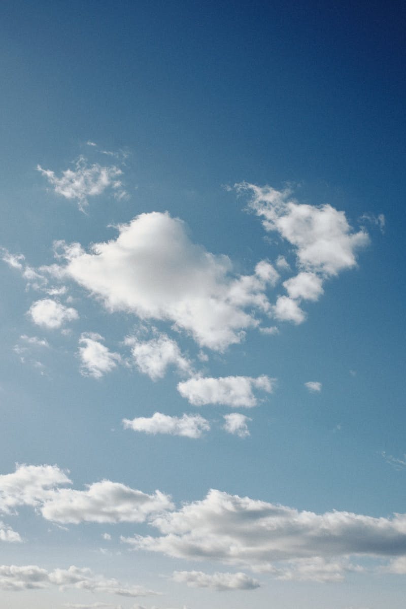 A person flying a kite in a blue sky