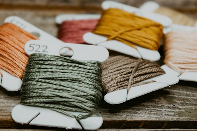 green and yellow yarn on brown wooden table