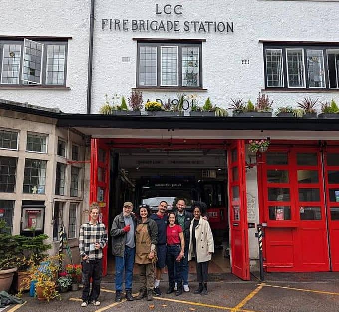 Hannah with volunteer group outside FIre Station with plants