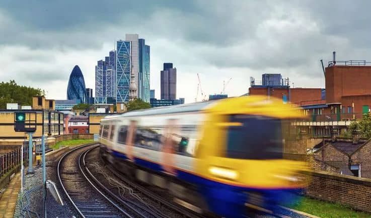 fast moving train with london skyline in the background