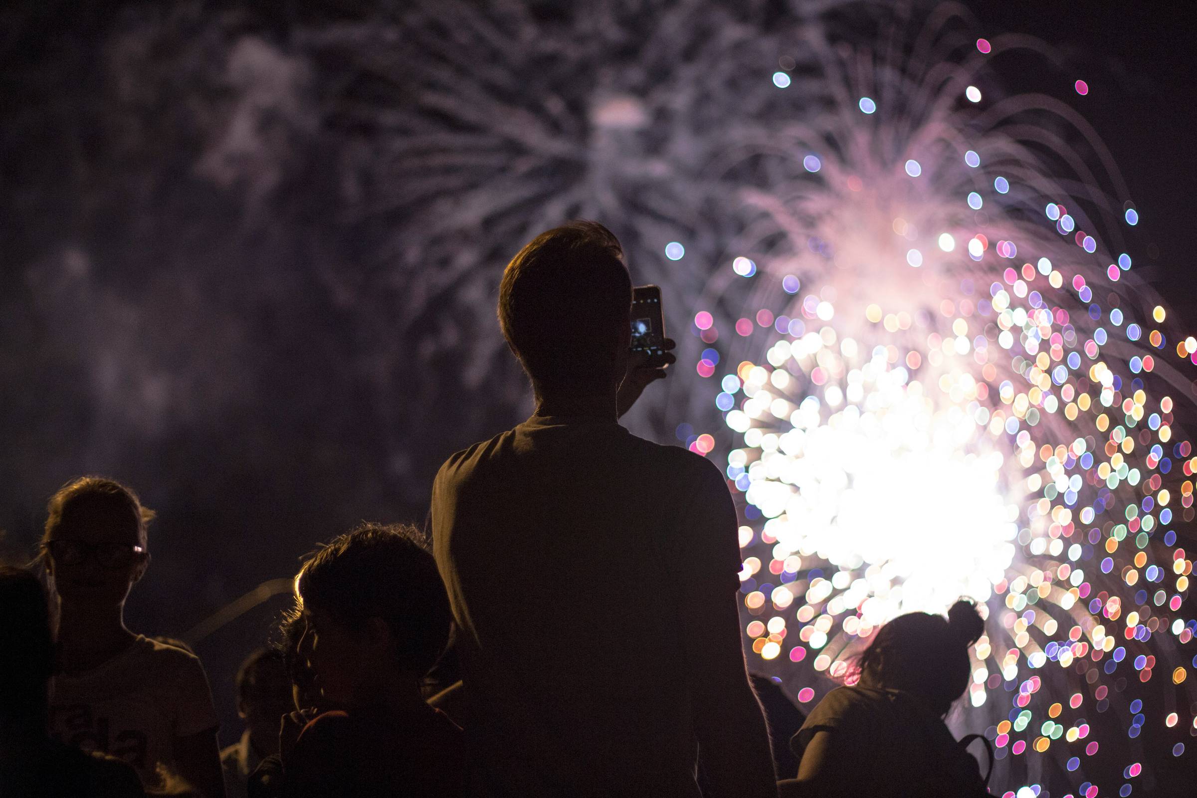 people taking images of fireworks outsidee