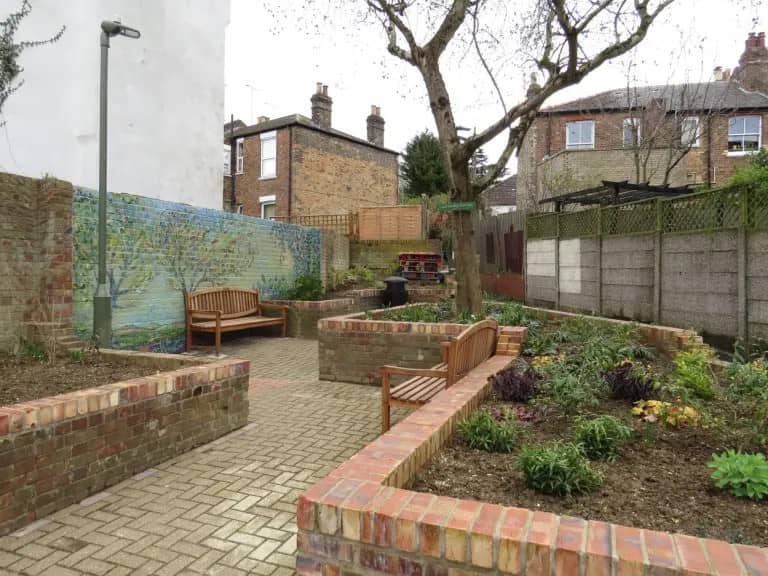 newly planted garden with seating area