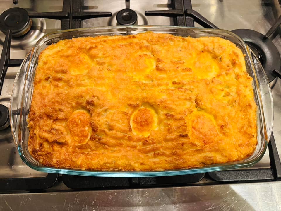 big dish of cheesy mashed potatoes with baked eggs