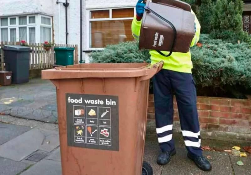 brown food waste bin + small brown bin being emptied into it