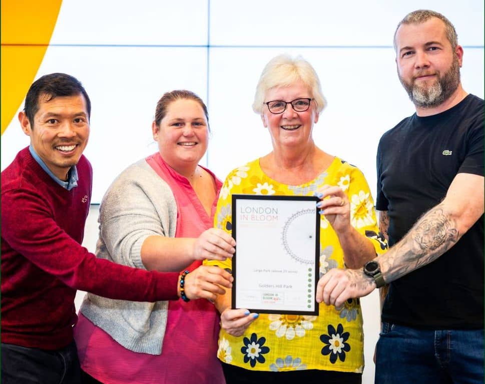 4 people holding an award certificate