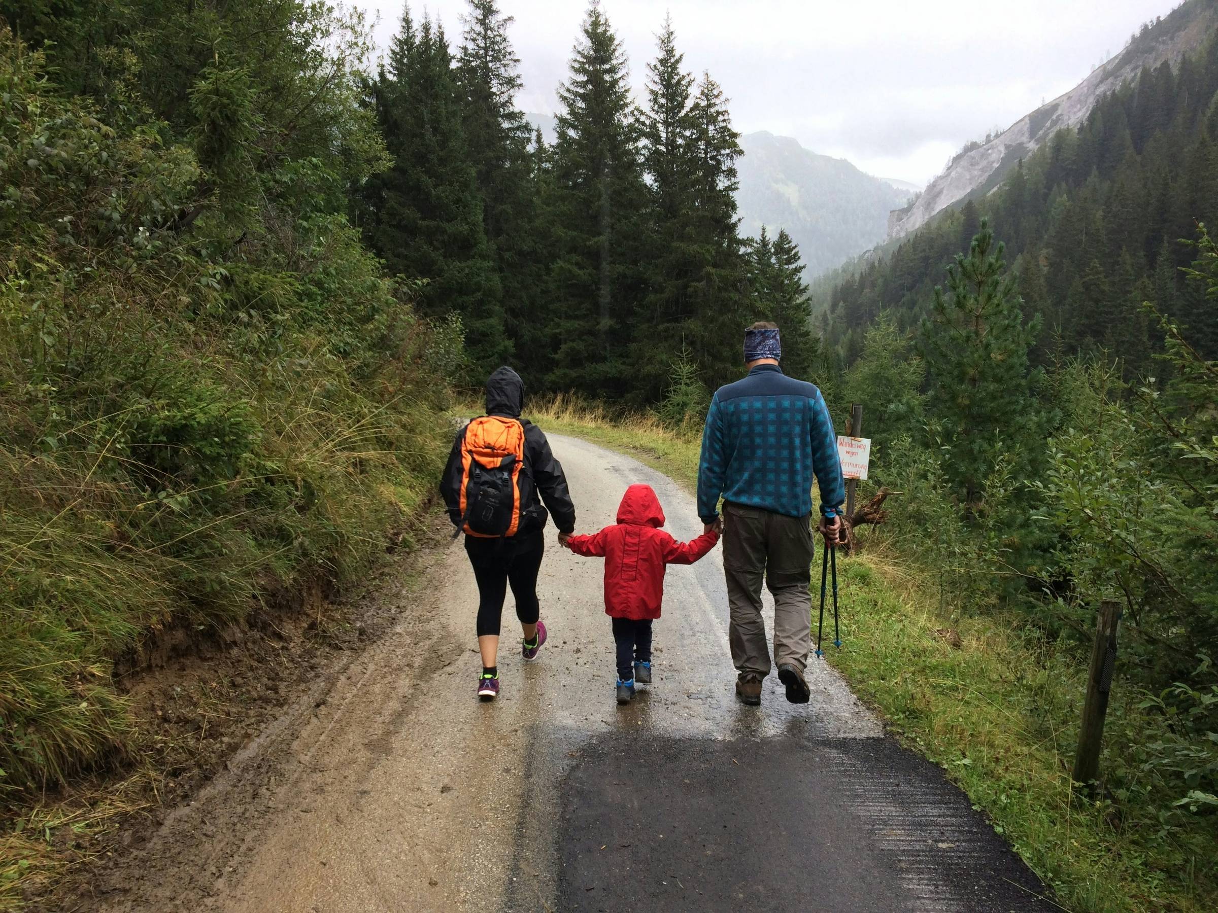 family hiking up a path