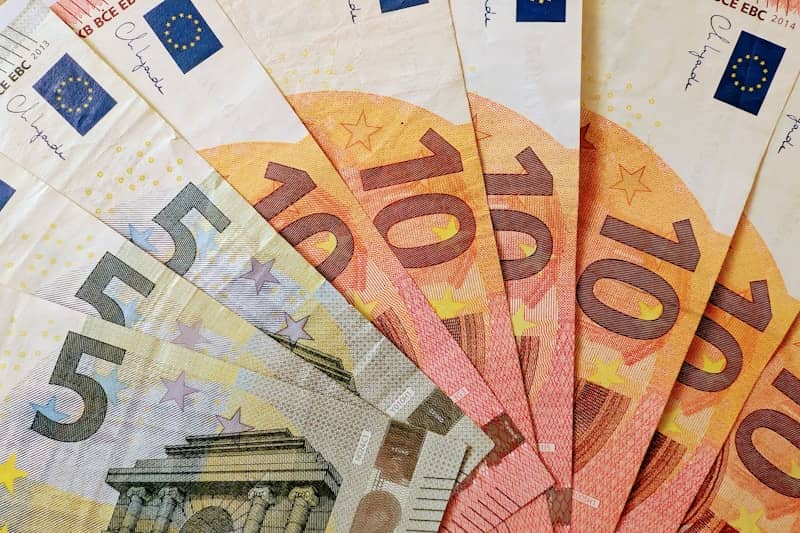 Euro banknotes fanned out, showing denominations.