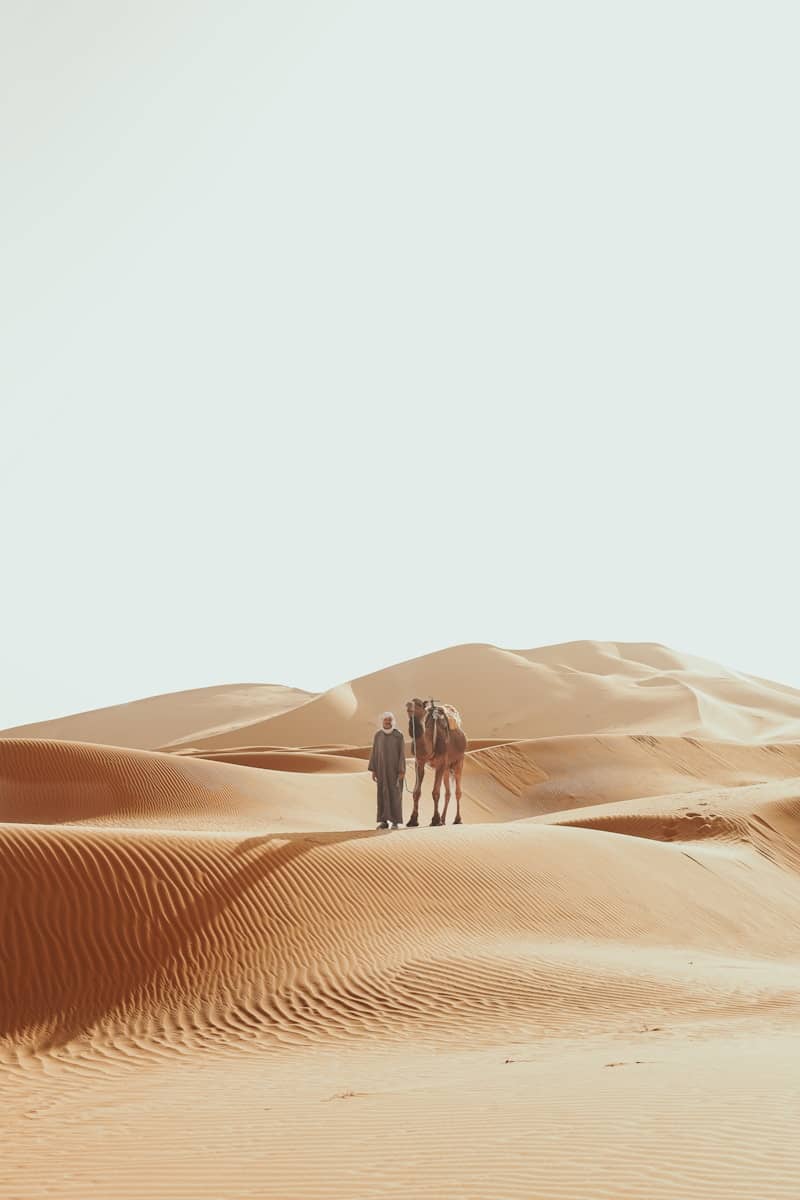 Two people standing in the middle of a desert