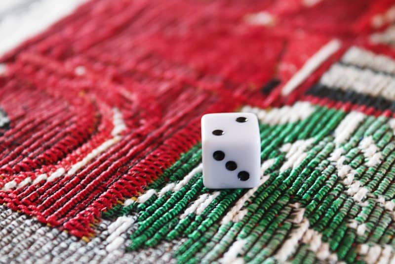 A close up of a dice on a rug