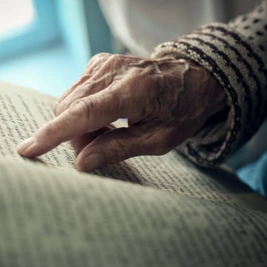 persons hand on white textile