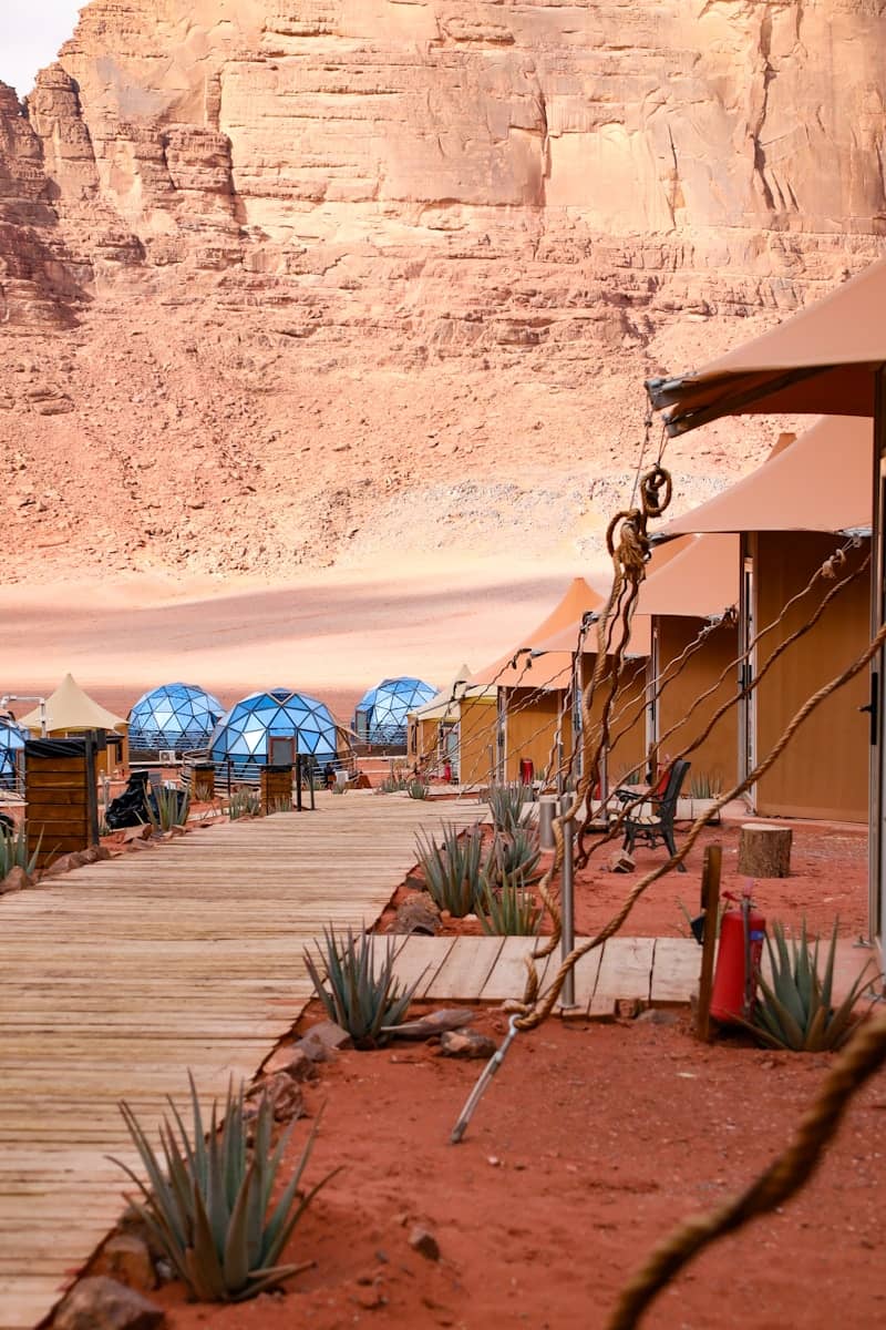 Desert camp with tents and geodesic domes.