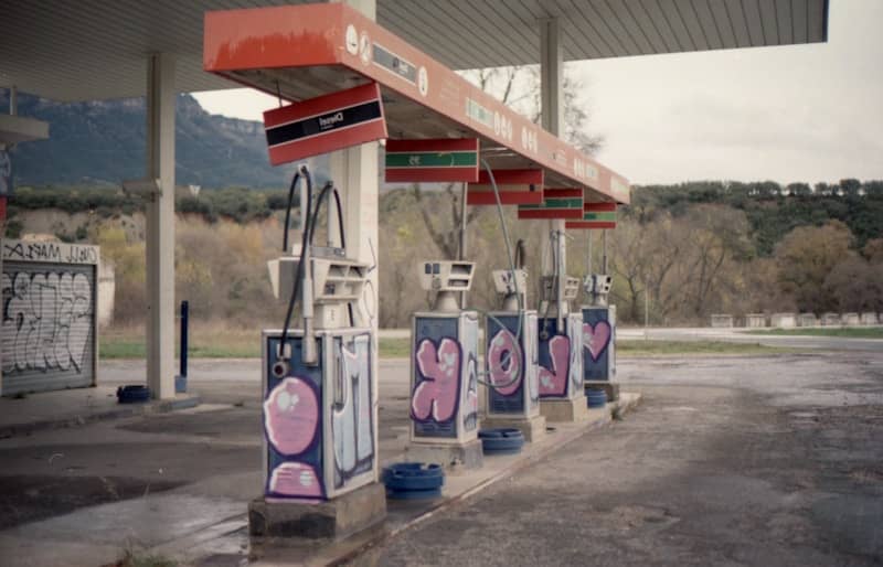 Graffiti-covered gas pumps at an abandoned station