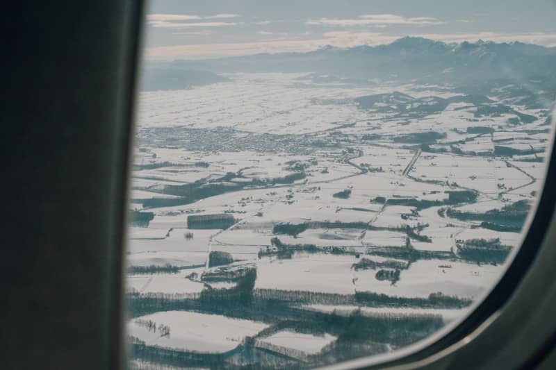 Snowy landscape viewed from an airplane window