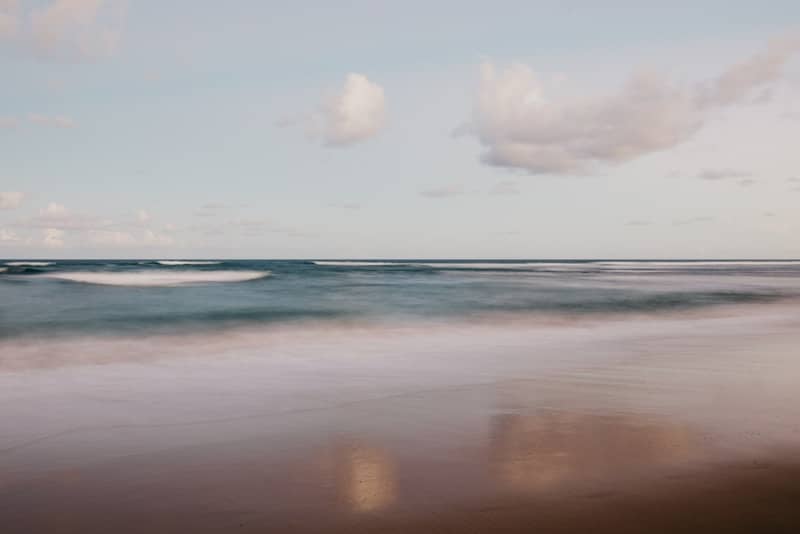 Ocean waves gently rolling onto a sandy shore.
