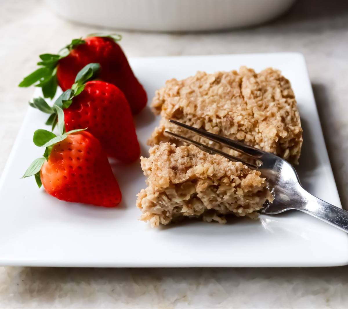 Banana Oatmeal Bar with Strawberries on White Plate