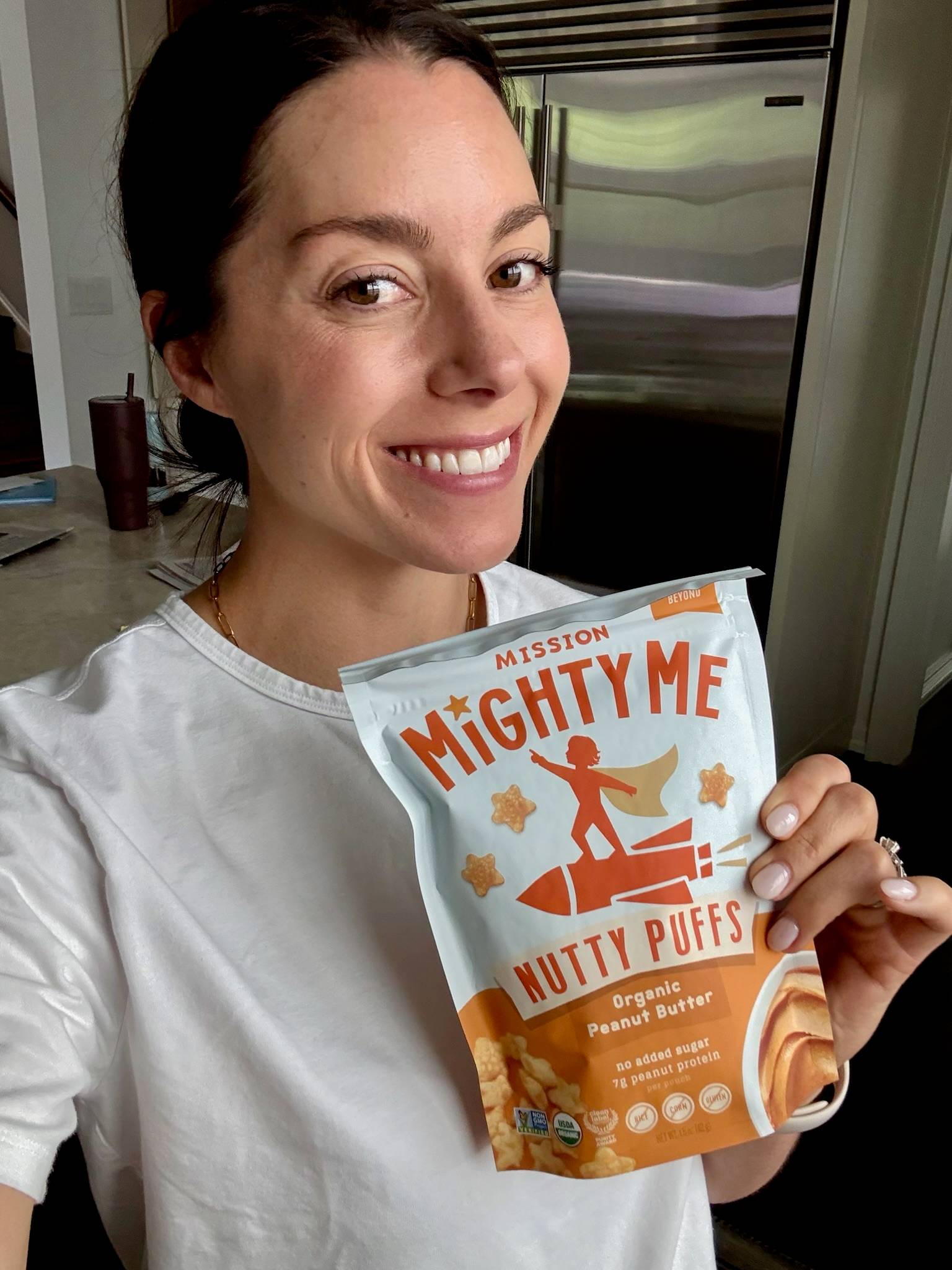 Kacie Barnes Holding Mission MightyMe Nutty Puffs