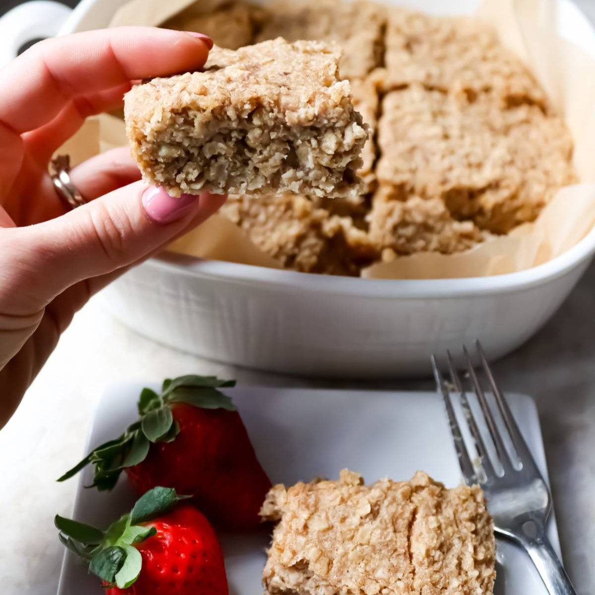 Hand holding sliced banana oatmeal bar