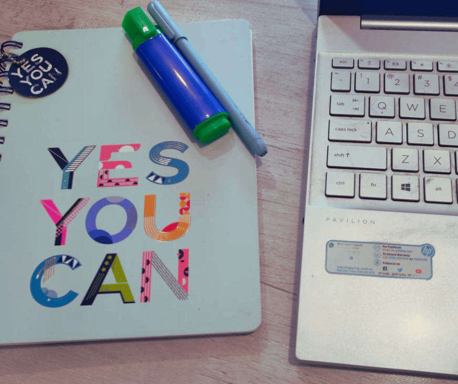 a notebook with Yes You Can written on it