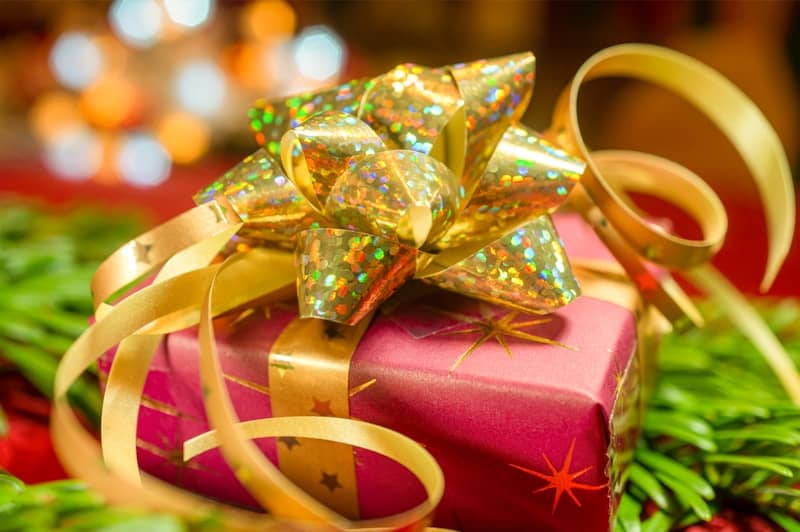 A close up of a present wrapped in gold ribbon