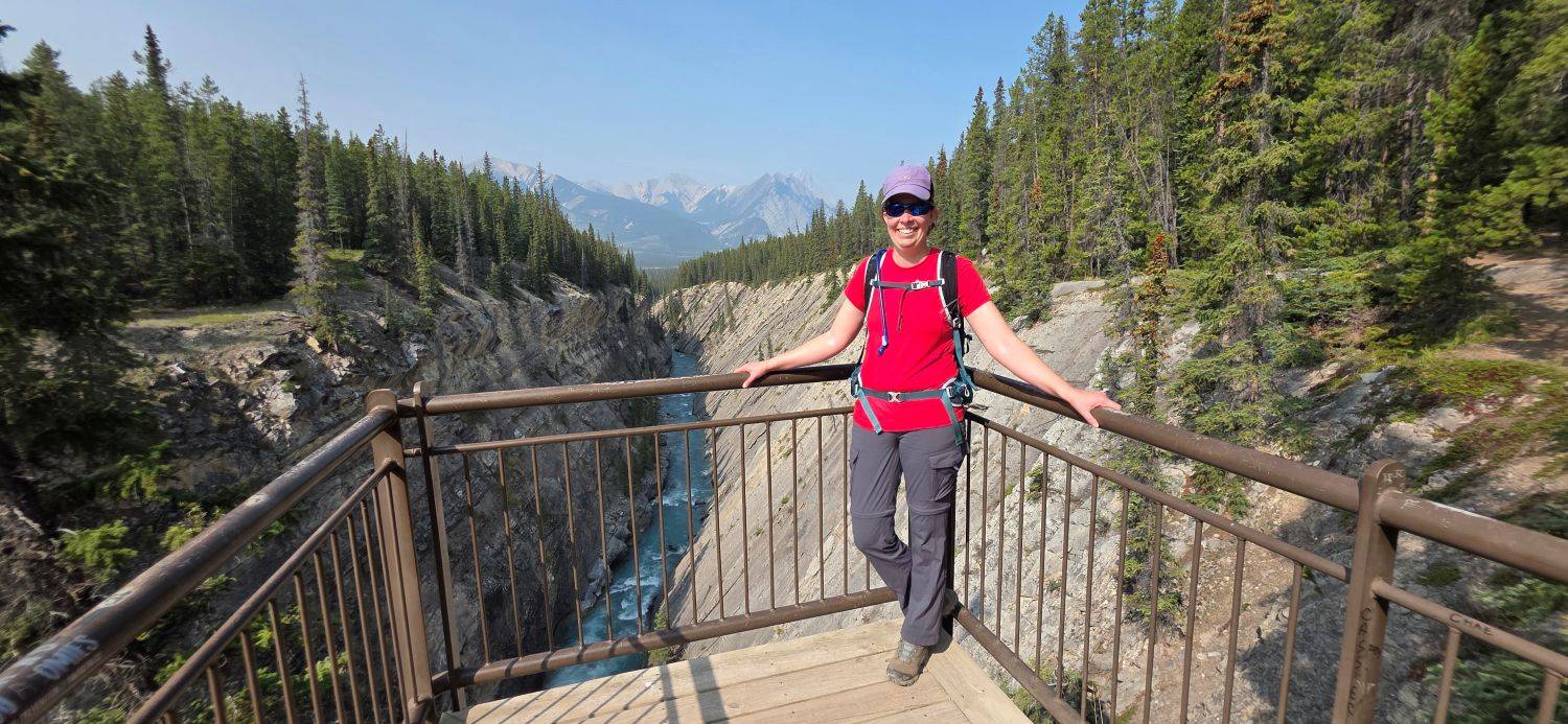 Lady standing on viewing platform above Siffleur Falls gorge.