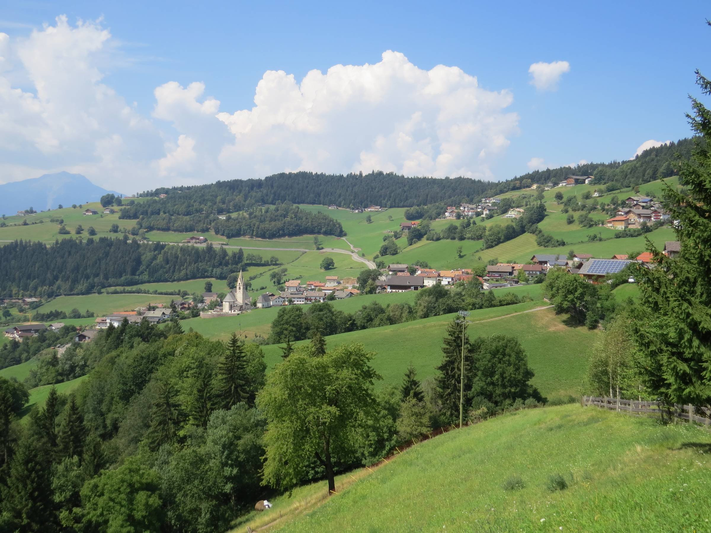 Looking at the town of Mölten, Italy nestled in the foothills