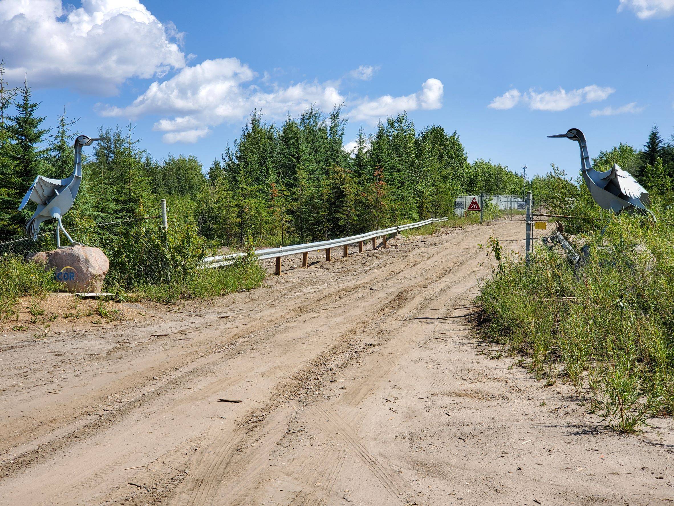 two metals cranes on either side of the road